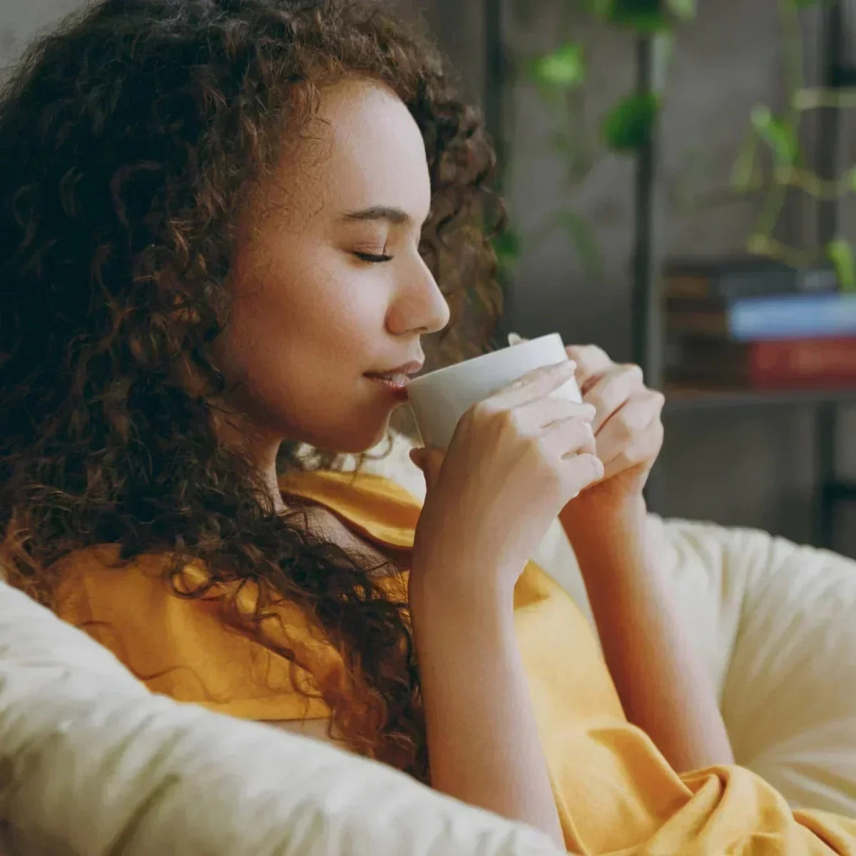 Woman drinking from cup.