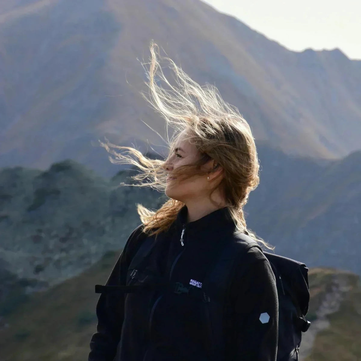 Female mountaineer with wind in her face.